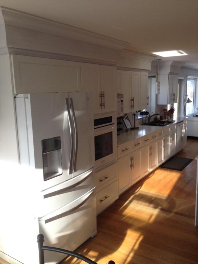 These cabinets used to be oak. The white refacing really brought a modern, clean look to this kitchen.